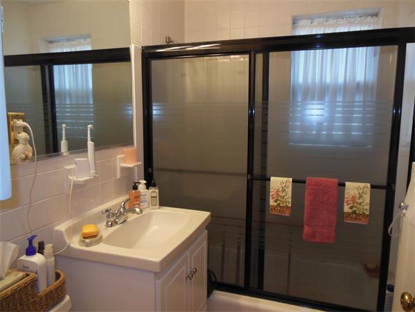 22 Jacqueline Road, Unit D Waltham, MA 02452 - Photo 9 of 11 a bathroom with a sink and a mirror