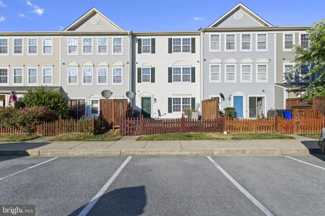 a front view of a residential apartment building with a yard