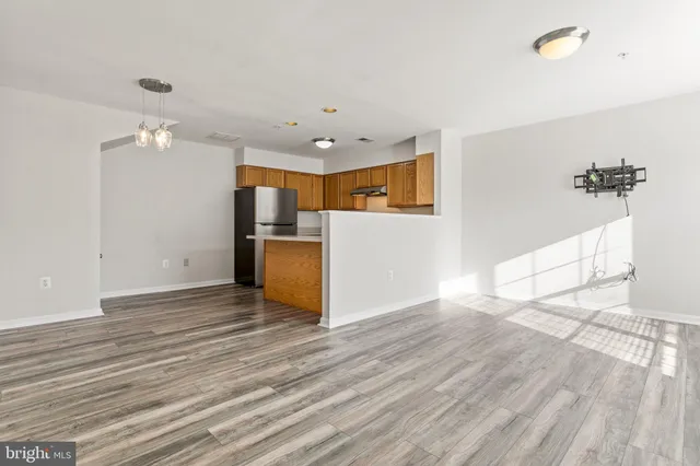 a view of a kitchen with a sink cabinet a microwave and cabinets