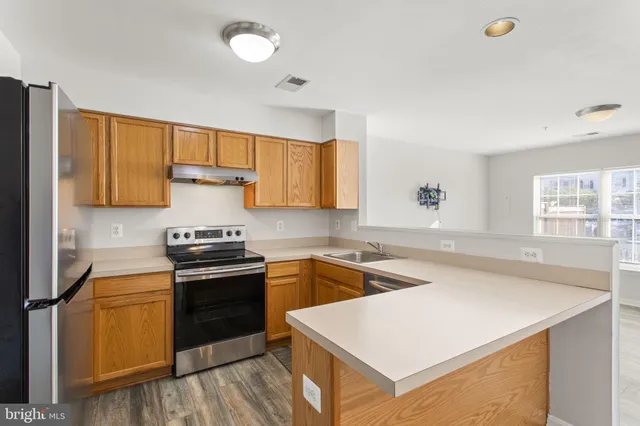 a kitchen with a stove a sink and a refrigerator