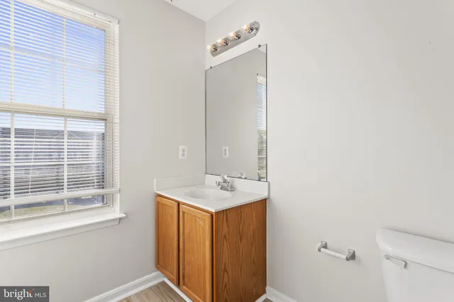 a bathroom with a sink a mirror and a window