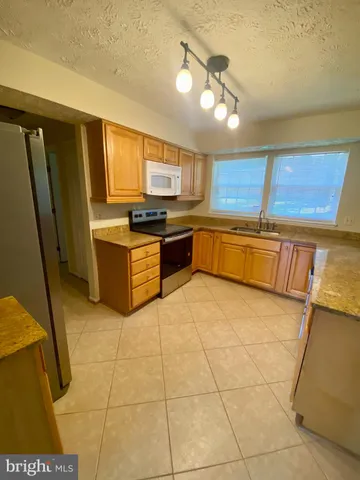 a kitchen with stainless steel appliances granite countertop a sink and cabinets
