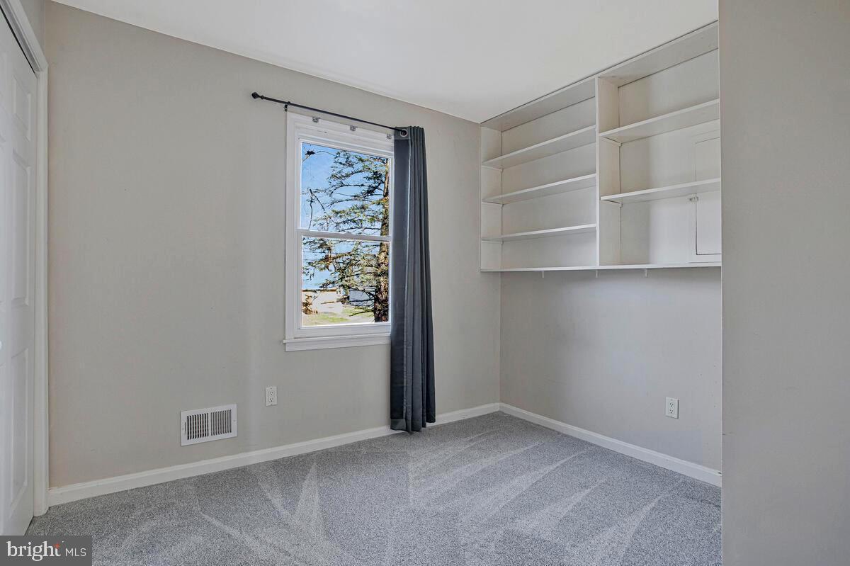 735 Whitehall Beach Road Annapolis, MD 21409 - Photo 10 of 35 a view of an empty room with shelves