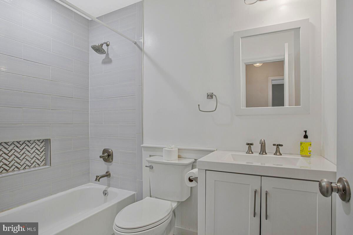 735 Whitehall Beach Road Annapolis, MD 21409 - Photo 12 of 35 a bathroom with a sink toilet and shower