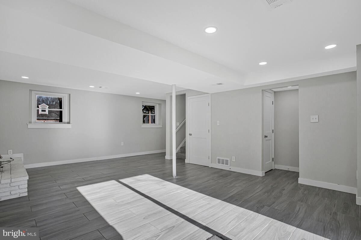 735 Whitehall Beach Road Annapolis, MD 21409 - Photo 19 of 35 an empty room with wooden floor and windows