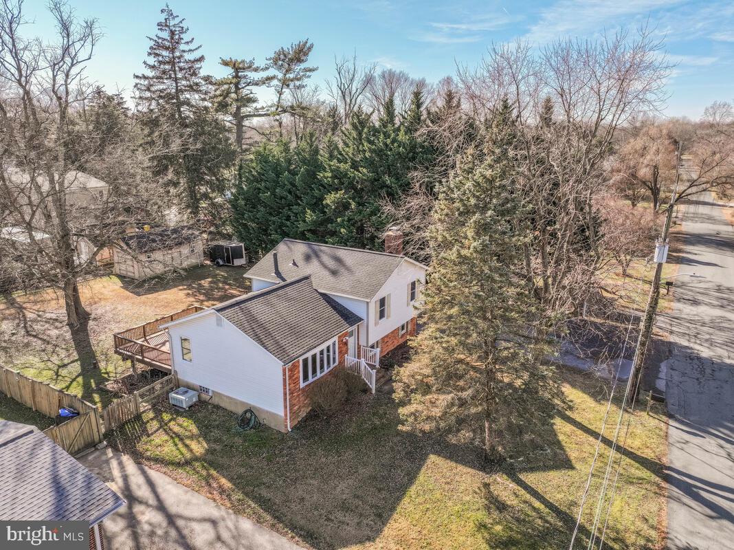 735 Whitehall Beach Road Annapolis, MD 21409 - Photo 31 of 35 a view of a house with a yard and large trees