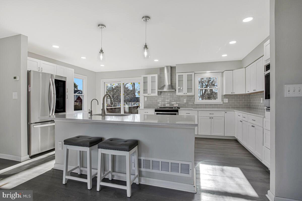 735 Whitehall Beach Road Annapolis, MD 21409 - Photo 5 of 35 a kitchen with refrigerator and cabinets