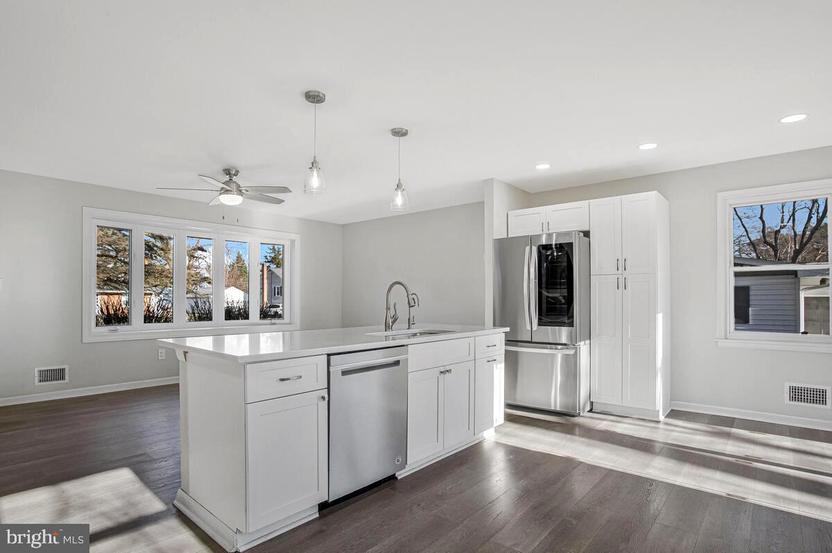 735 Whitehall Beach Road Annapolis, MD 21409 - Photo 8 of 35 a kitchen with white cabinets and sink