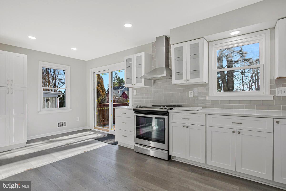 735 Whitehall Beach Road Annapolis, MD 21409 - Photo 9 of 35 a kitchen with granite countertop white cabinets and window