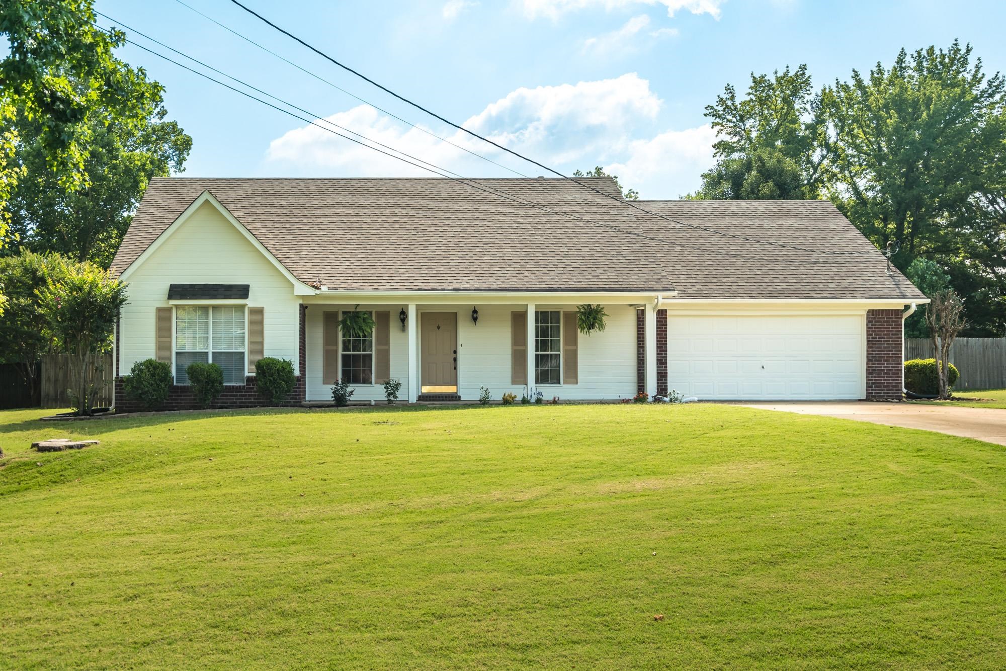 a view of a house with a backyard and basketball court