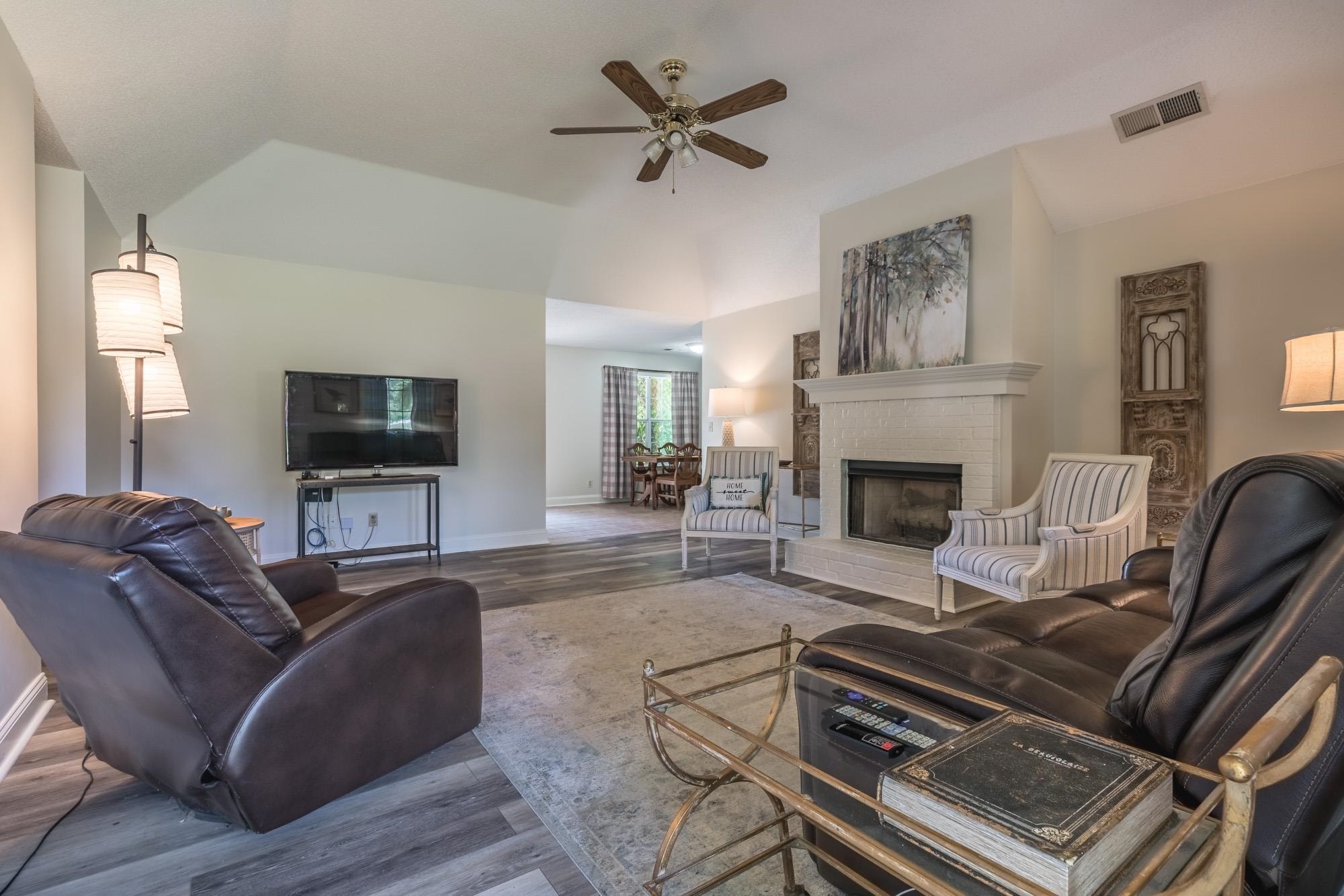 192 Madison Drive Atoka, TN 38004 - Photo 5 of 23 a living room with furniture a flat screen tv and a fireplace