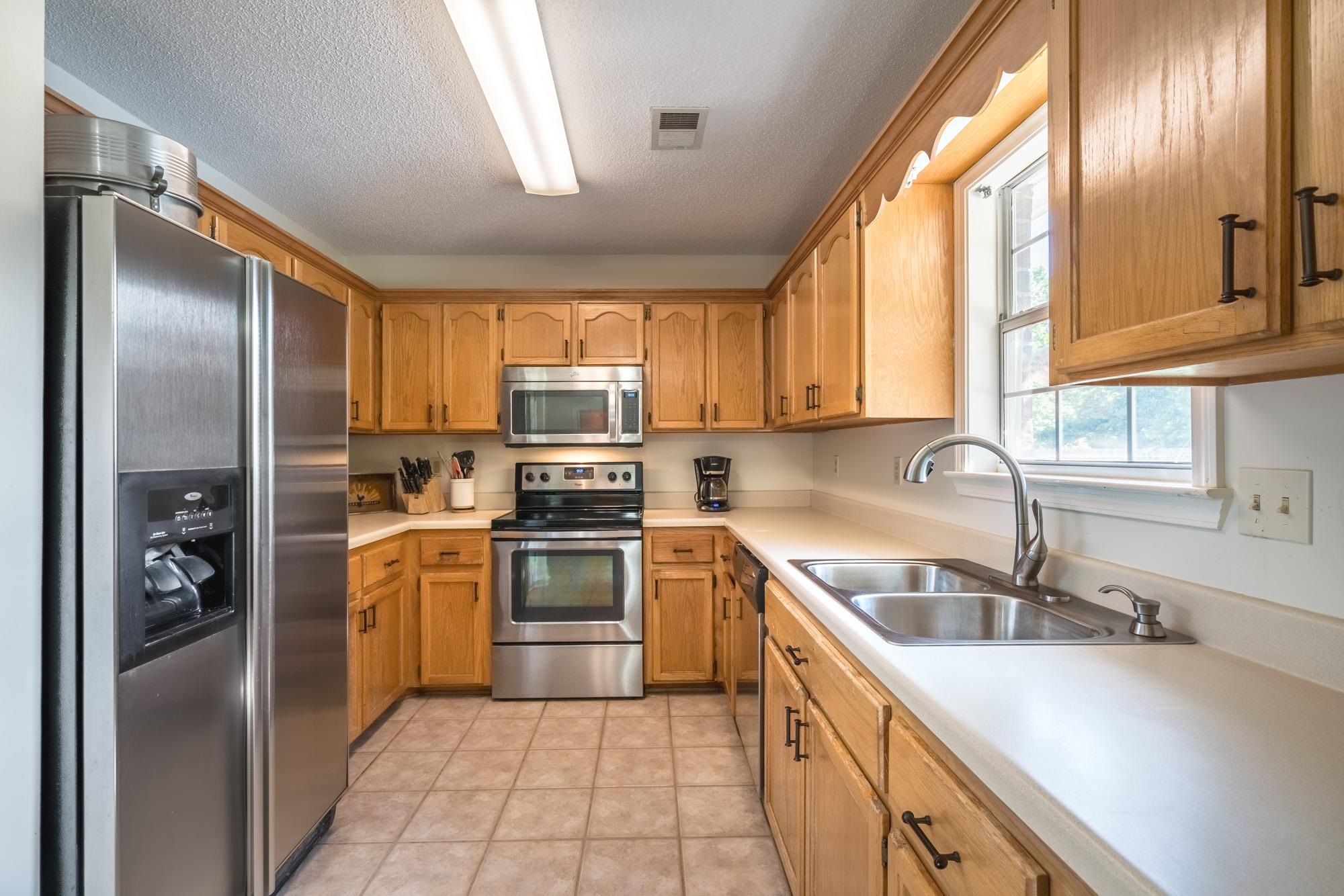 192 Madison Drive Atoka, TN 38004 - Photo 7 of 23 a kitchen with a refrigerator sink and cabinets