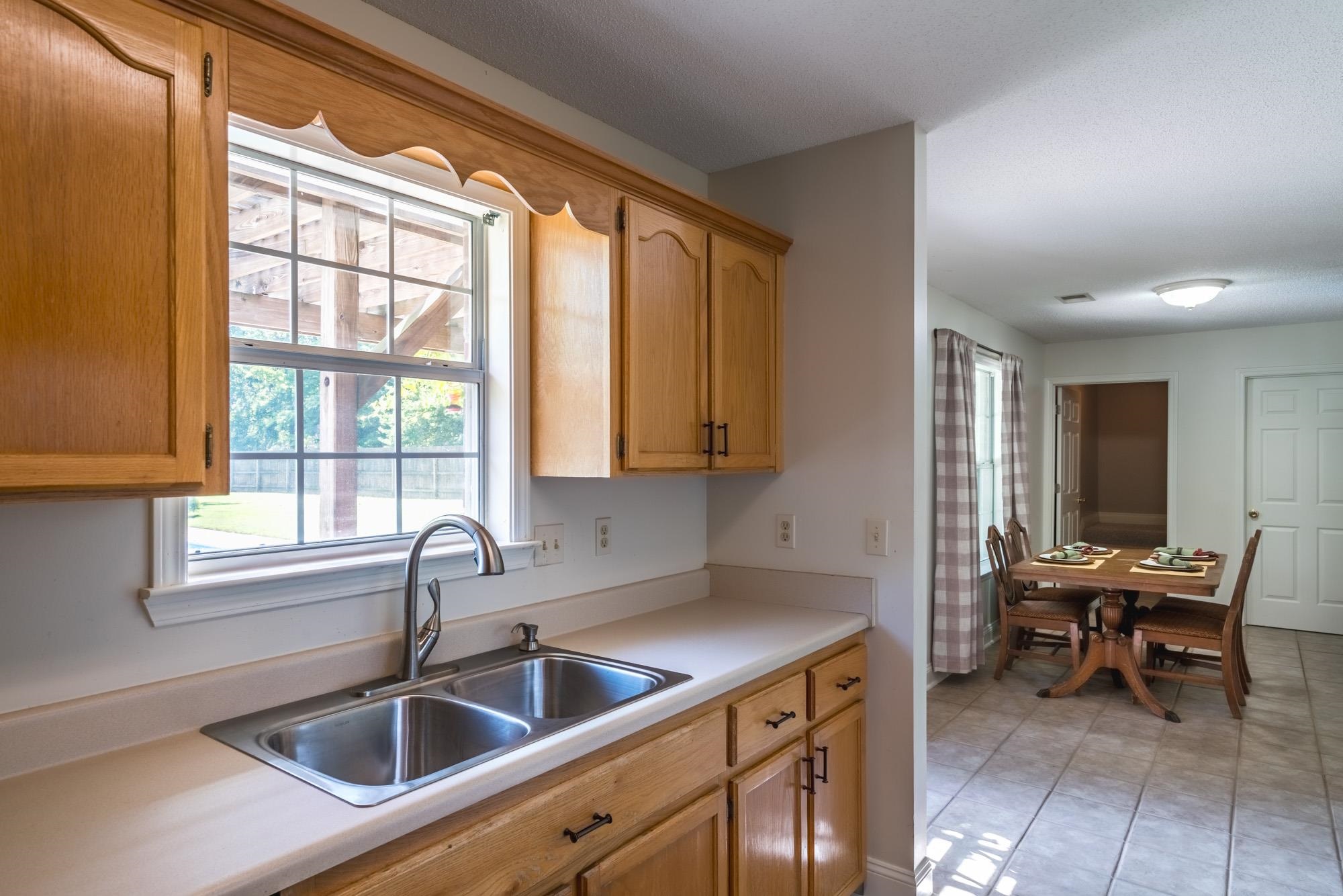 192 Madison Drive Atoka, TN 38004 - Photo 8 of 23 a kitchen that has a sink and chairs