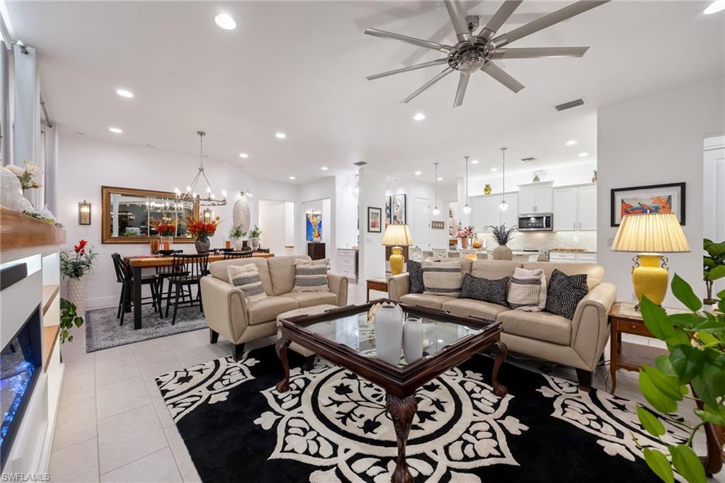 3620 Pilot Circle Naples, FL 34120 - Photo 15 of 49 a living room with furniture a table and a chandelier