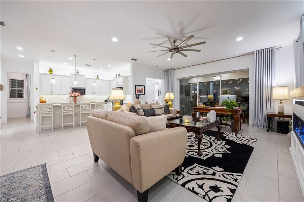 3620 Pilot Circle Naples, FL 34120 - Photo 16 of 49 a living room with furniture and a large window