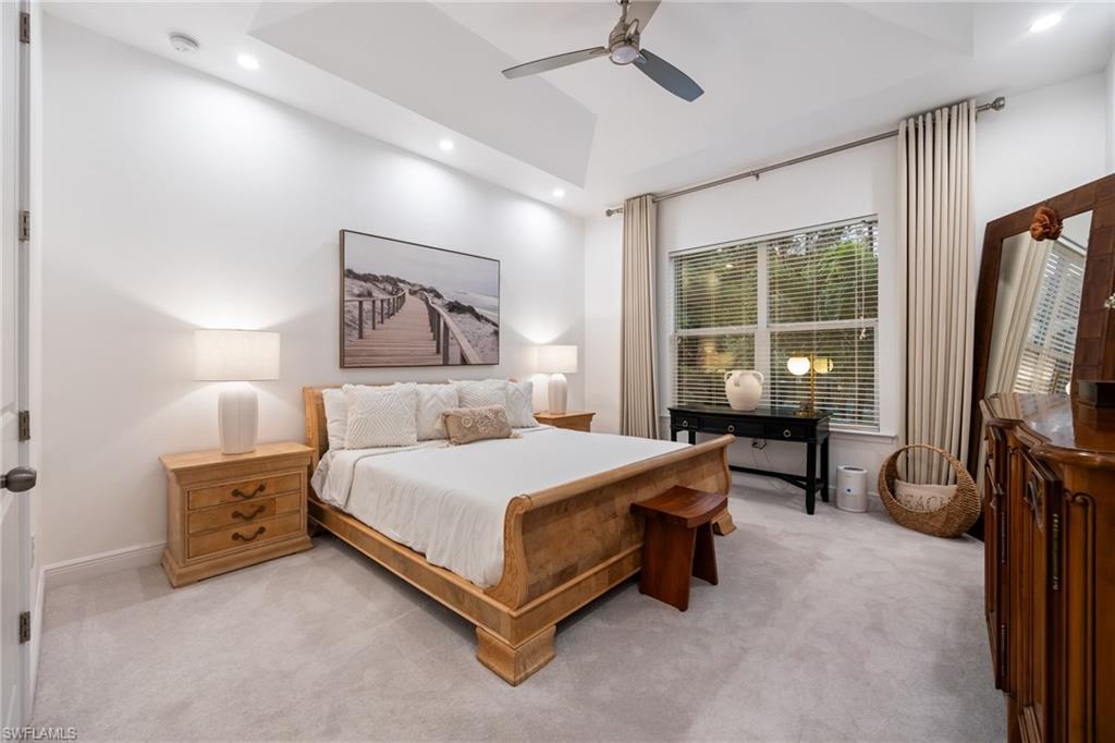 3620 Pilot Circle Naples, FL 34120 - Photo 21 of 49 a bedroom with a bed chair and a flat tv screen on the dresser