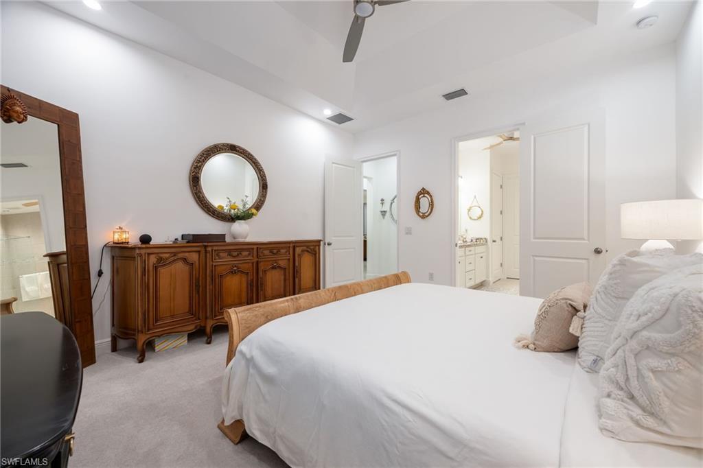 3620 Pilot Circle Naples, FL 34120 - Photo 22 of 49 a bedroom with a bed and a chandelier