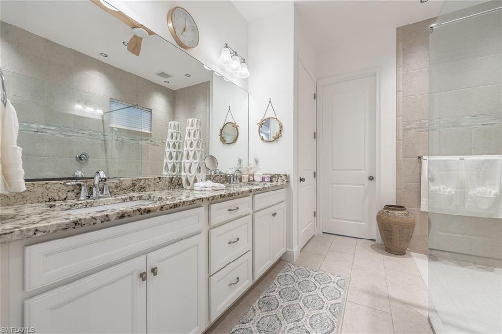 3620 Pilot Circle Naples, FL 34120 - Photo 23 of 49 a spacious bathroom with a granite countertop double vanity sink and a mirror