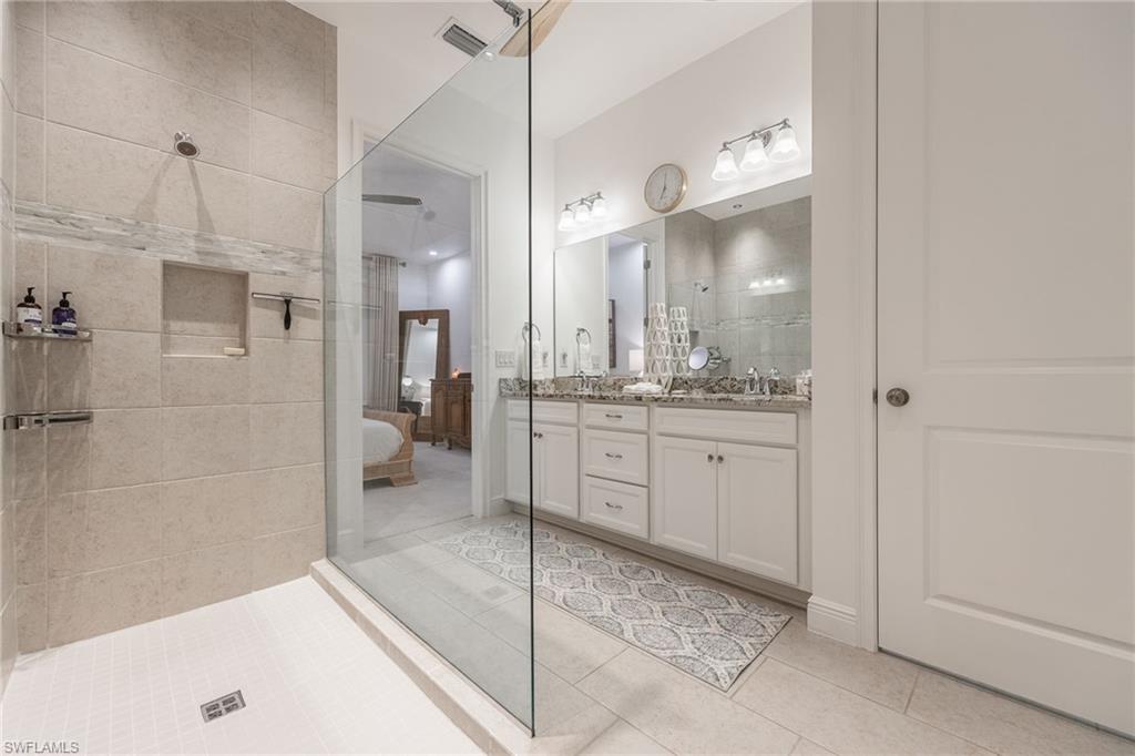 3620 Pilot Circle Naples, FL 34120 - Photo 25 of 49 a bathroom with a granite countertop sink mirror and shower