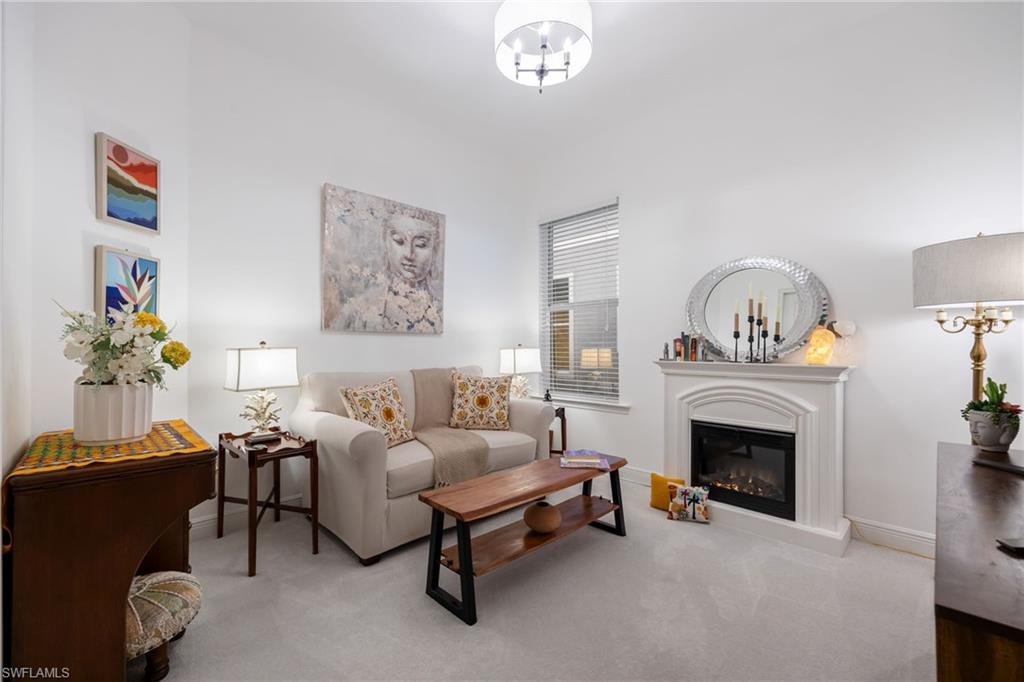 3620 Pilot Circle Naples, FL 34120 - Photo 28 of 49 a living room with furniture a fireplace and a potted plant