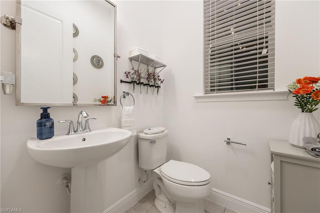 3620 Pilot Circle Naples, FL 34120 - Photo 29 of 49 a bathroom with a sink a toilet and mirror