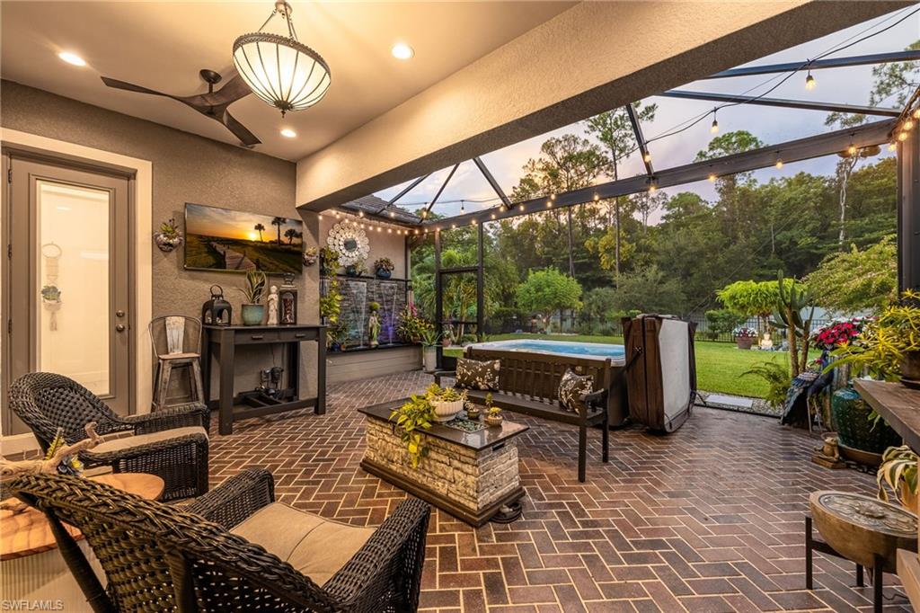 3620 Pilot Circle Naples, FL 34120 - Photo 33 of 49 a living room with furniture a dining table and a floor to ceiling window