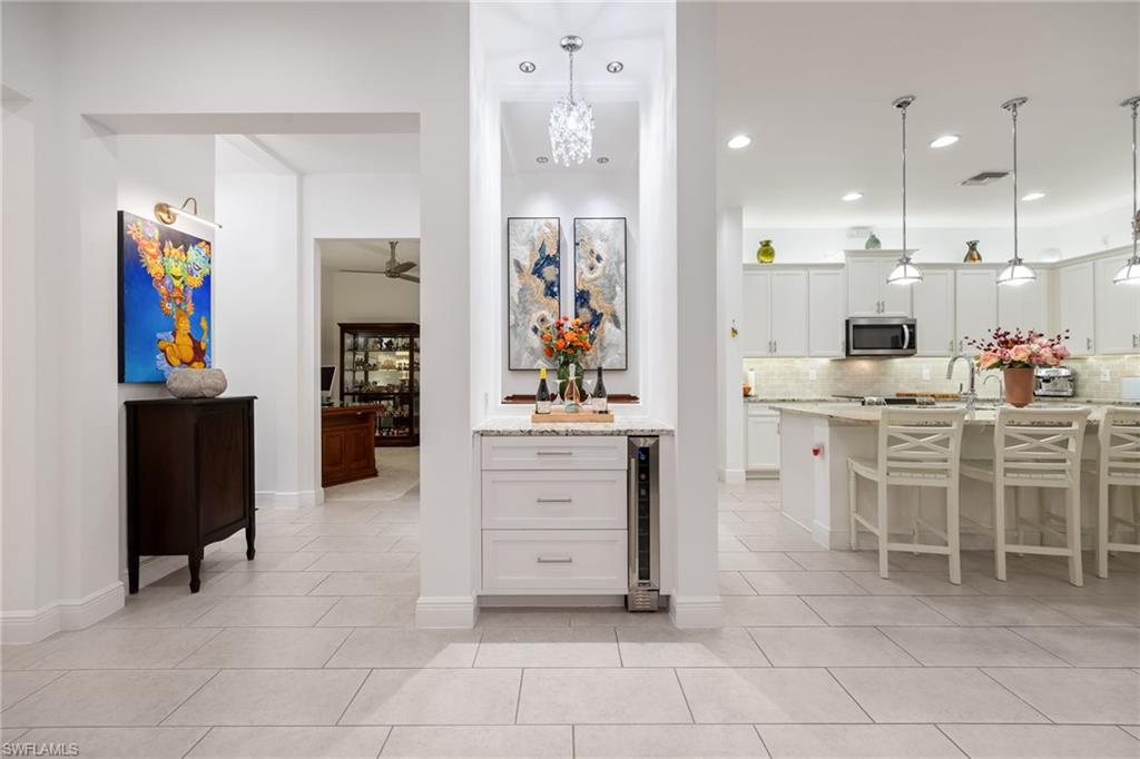 3620 Pilot Circle Naples, FL 34120 - Photo 7 of 49 a view of kitchen with stainless steel appliances kitchen island granite countertop a refrigerator and cabinets