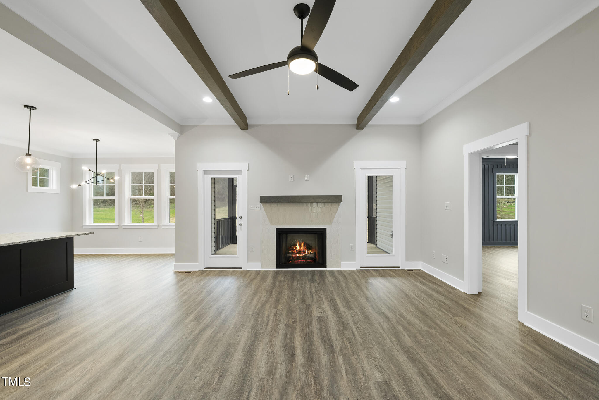 100 Pilot Ridge Road Zebulon, NC 27597 - Photo 5 of 29 an empty room with wooden floor fireplace and windows