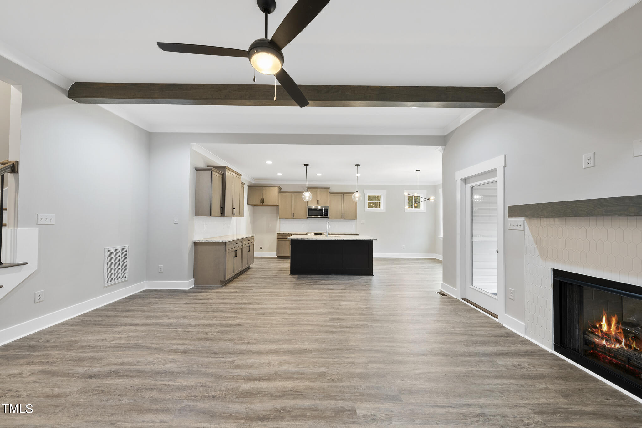 100 Pilot Ridge Road Zebulon, NC 27597 - Photo 7 of 29 a large white kitchen with a sink stainless steel appliances and a fireplace