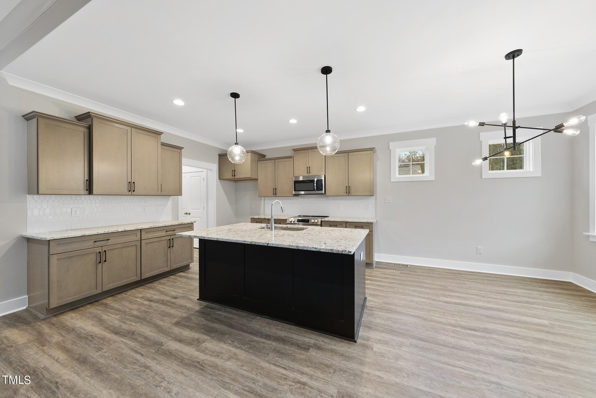 100 Pilot Ridge Road Zebulon, NC 27597 - Photo 8 of 29 a large kitchen with kitchen island a sink stainless steel appliances and cabinets