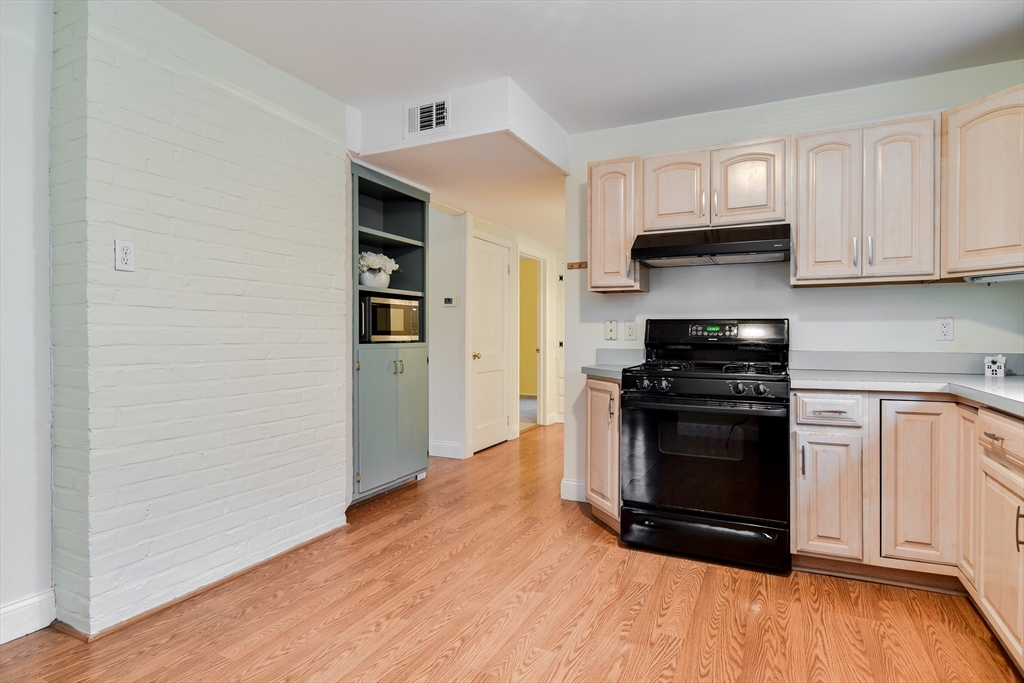 10 Kelsey Road Natick, MA 01760 - Photo 11 of 24 a kitchen with stainless steel appliances granite countertop a stove and a refrigerator