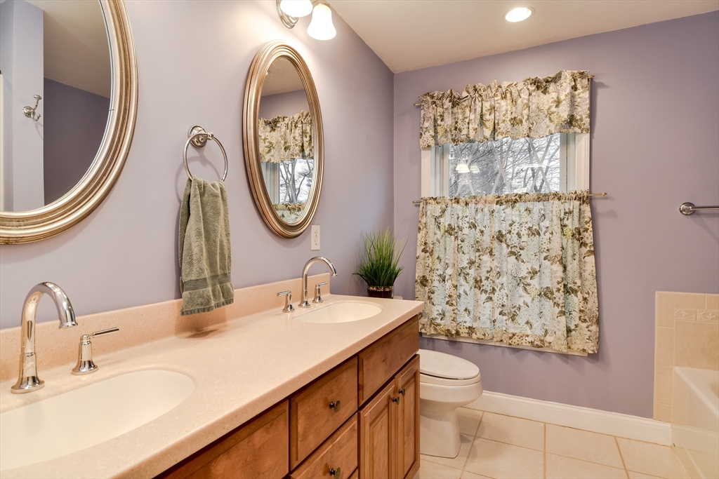 10 Kelsey Road Natick, MA 01760 - Photo 19 of 24 a bathroom with a toilet a sink and a mirror