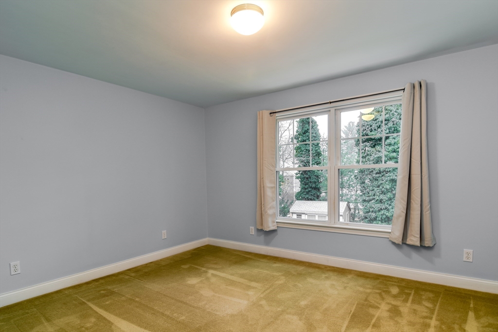 10 Kelsey Road Natick, MA 01760 - Photo 22 of 24 a view of an empty room with a tub and large windows
