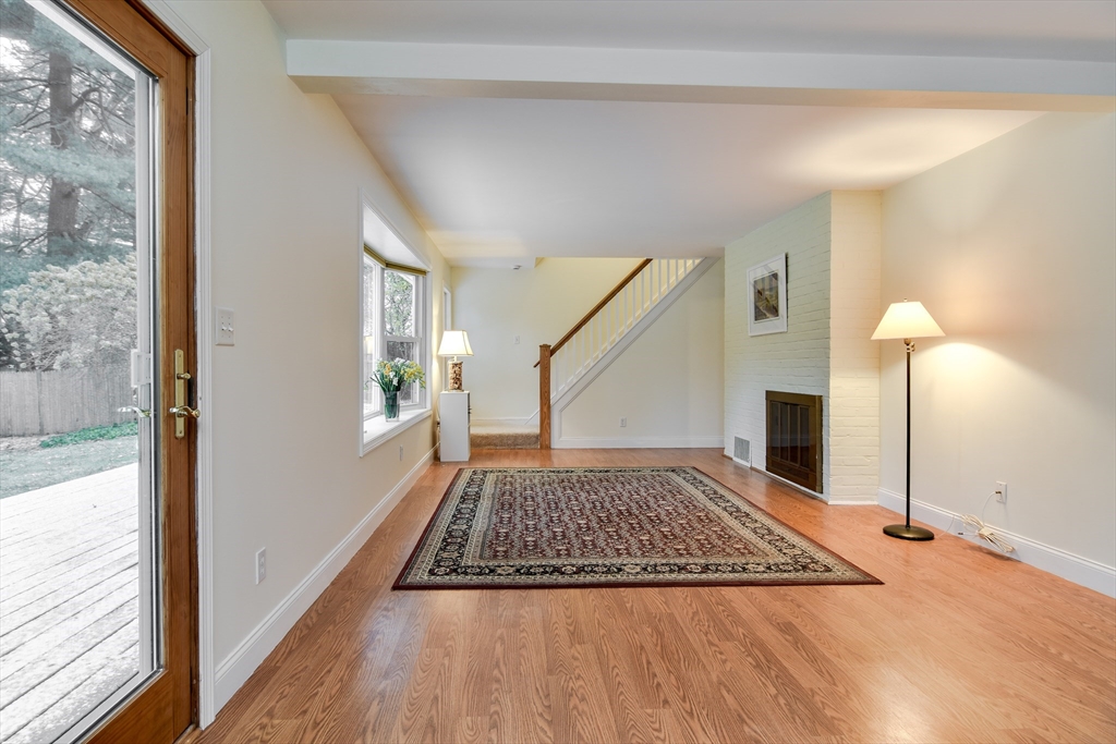 10 Kelsey Road Natick, MA 01760 - Photo 6 of 24 a view of a livingroom with wooden floor and fireplace