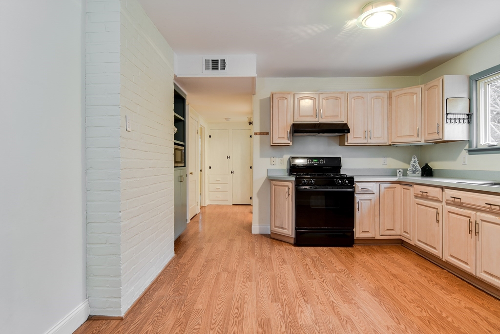 10 Kelsey Road Natick, MA 01760 - Photo 9 of 24 a kitchen with granite countertop a refrigerator stove top oven and sink