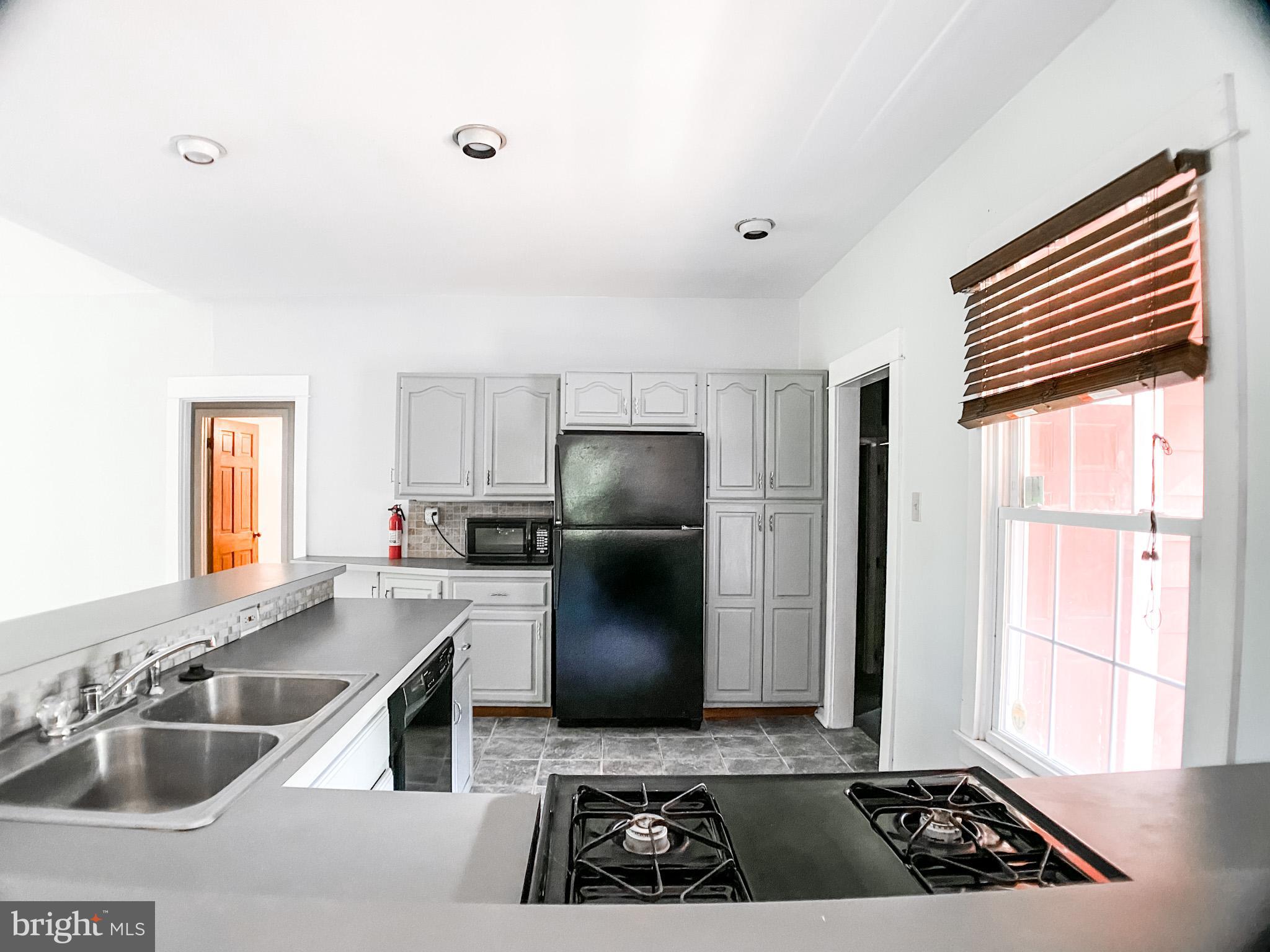 651 Lake Boulevard Lindenwold, NJ 08021 - Photo 16 of 37 a kitchen with a sink and a refrigerator