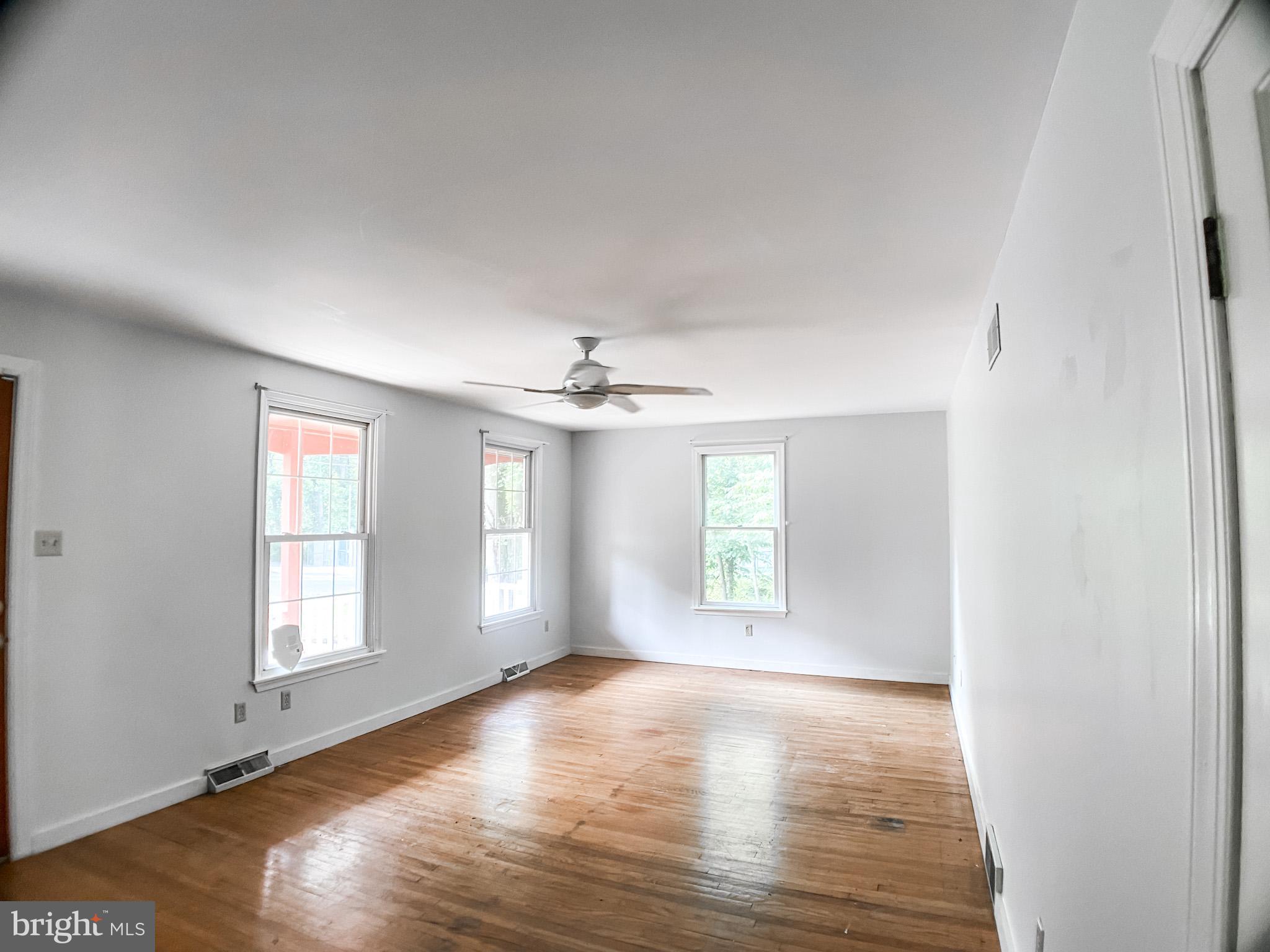 651 Lake Boulevard Lindenwold, NJ 08021 - Photo 17 of 37 an empty room with wooden floor and windows