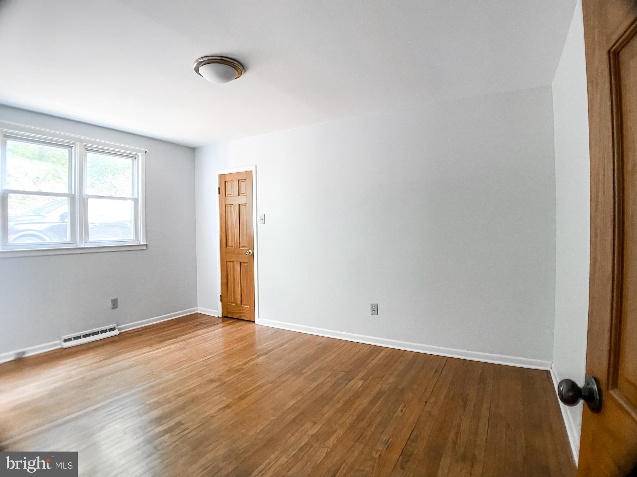 651 Lake Boulevard Lindenwold, NJ 08021 - Photo 22 of 37 an empty room with wooden floor and windows