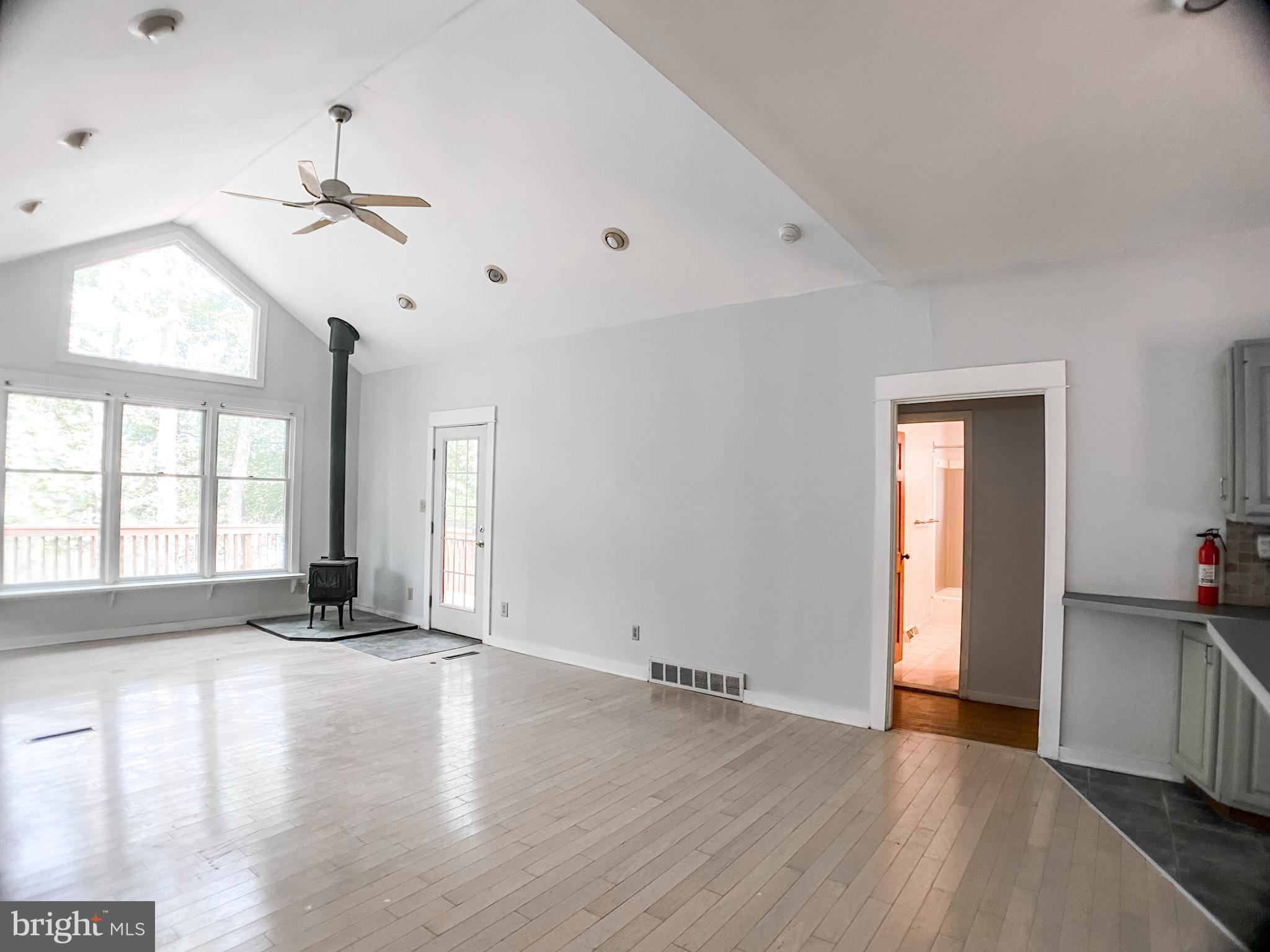 651 Lake Boulevard Lindenwold, NJ 08021 - Photo 5 of 37 a view of an empty room with a window and wooden floor