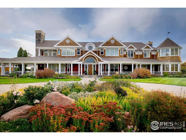 a front view of residential houses with yard and green space