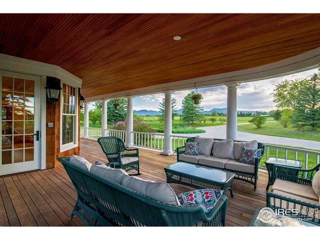a living room with furniture a large window and a fireplace