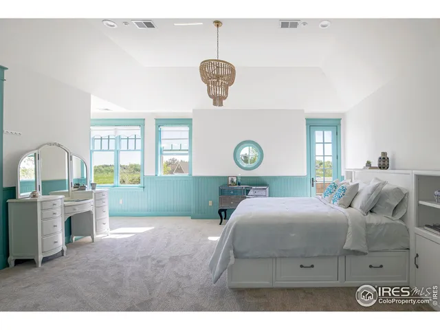 a spacious bedroom with a bed and a large window