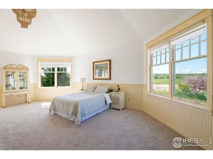 a living room with furniture floor to ceiling window and wooden floor