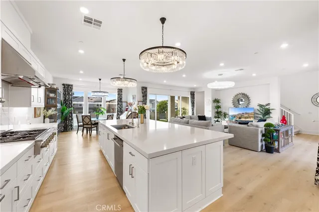 a kitchen with stainless steel appliances a sink stove and cabinets