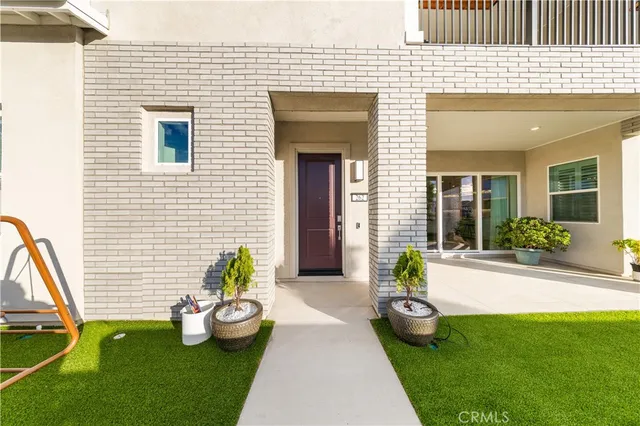 a view of a backyard with furniture and potted plants