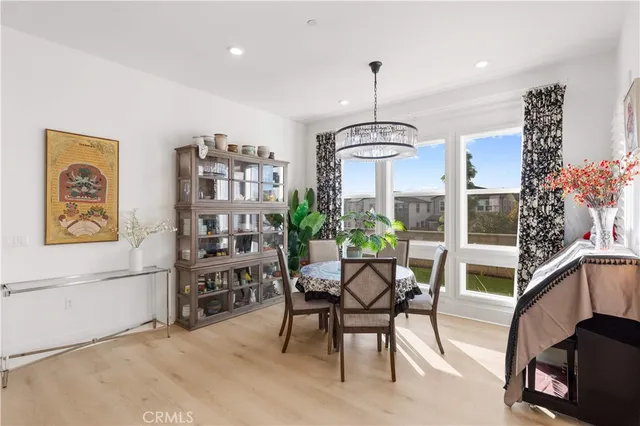 a view of a dining room filled with furniture and chandelier