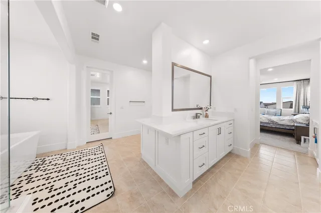 a bedroom with furniture and a large window