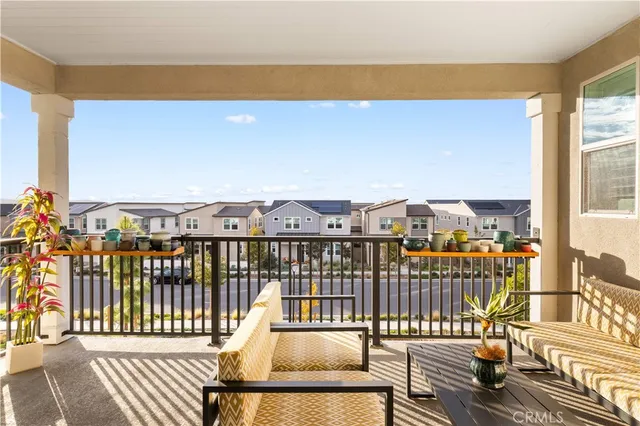 a view of a chairs and table in patio with a yard