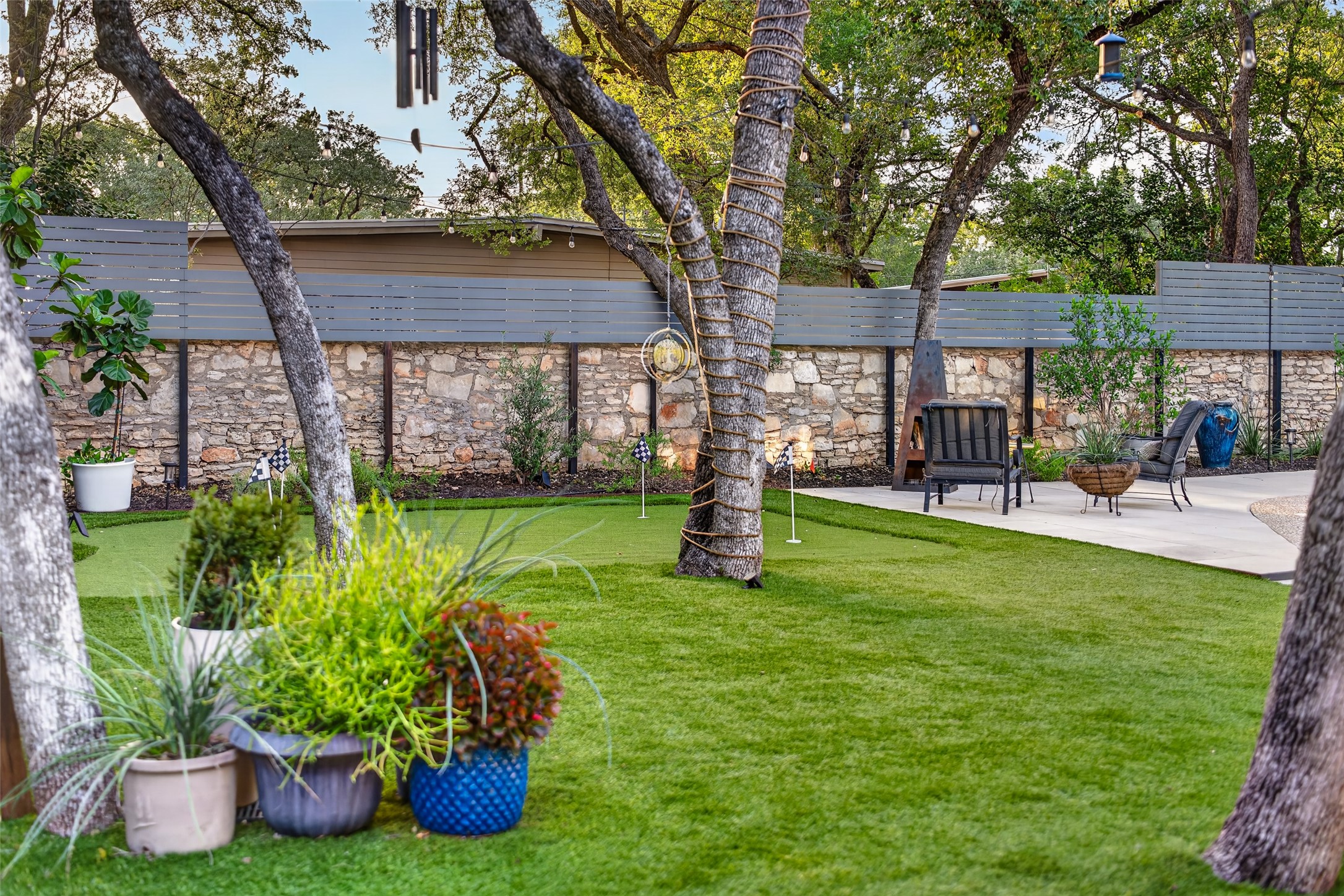 412 Ridgewood Road West Lake Hills, TX 78746 - Photo 29 of 40 Artificial turf backyard for low-maintenance care.