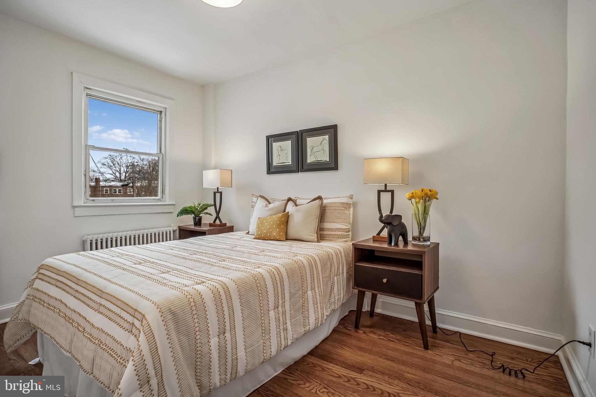 423 20th Street Northeast Washington, DC 20002 - Photo 29 of 35 a bedroom with a bed and a table